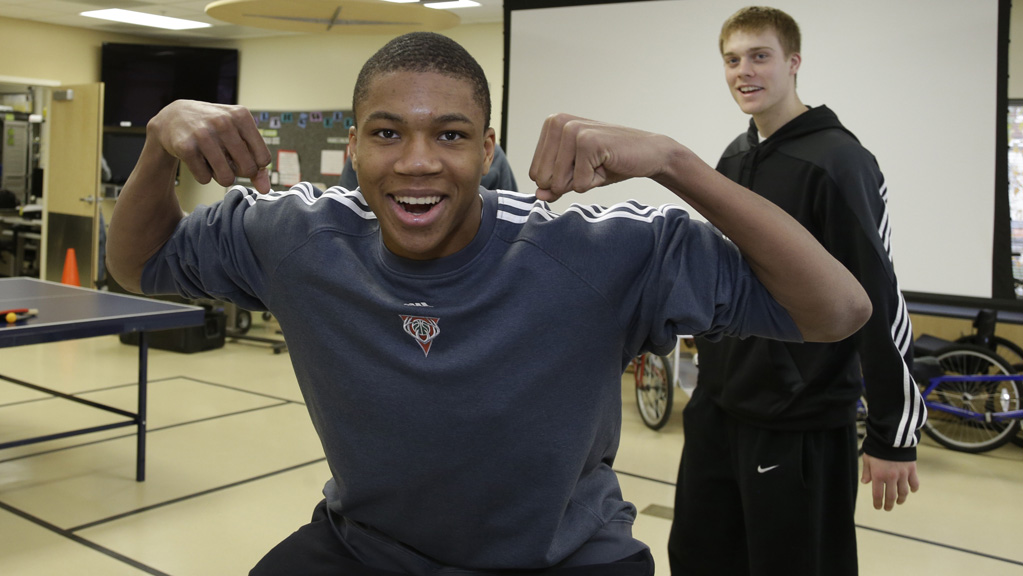 MILWAUKEE, WI - NOVEMBER 8:  Milwaukee Bucks player Giannis Antetokounmpo reacts with Nate Wolters,right, as they visit veterans as part of the NBA Cares Hoops for Troops program on  November 8, 2013 at Clement J. Zablocki VA Medical Center in Milwaukee, Wisconsin. NOTE TO USER:  User expressly acknowledges and agrees that, by downloading and or using this Photograph, user is consenting to the terms and conditions of the Getty Images License Agreement.  Mandatory Copyright Notice:  Copyright 2013 NBAE (Photo by Jeffrey Phelps/NBAE via Getty Images)